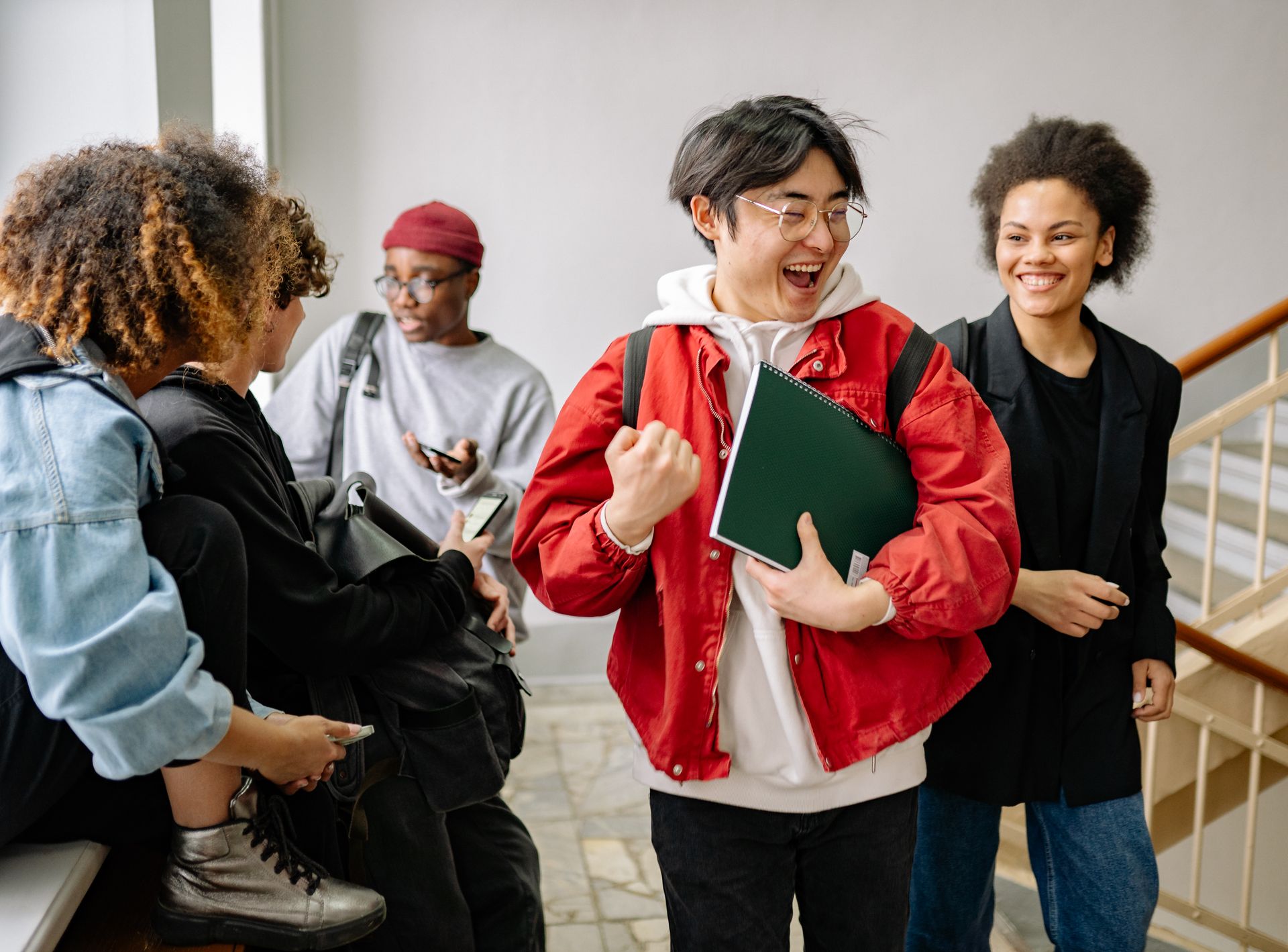 Group of diverse college students enjoying a modern university campus